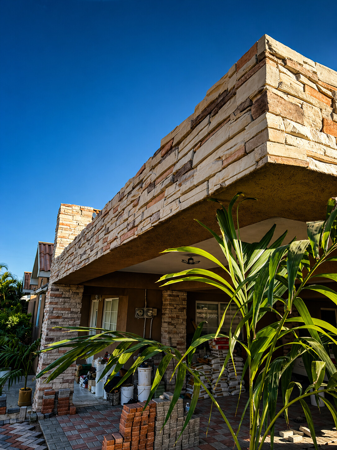 Limestone terrace beam and columns featuring ConCreate Rustic Stone Veneer
