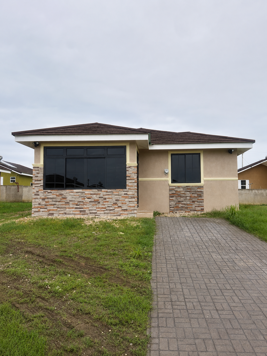 Window-base façade accents featuring ConCreate Rustic Stone Veneer